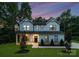 Charming two-story home featuring a landscaped yard, large windows, and a welcoming entrance at 6524 Robert St, Huntersville, NC 28078