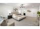 Main bedroom with sitting area, art, neutral walls, and modern chandelier at 6524 Robert St, Huntersville, NC 28078