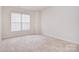 Carpeted bedroom with one window featuring window blinds providing natural light at 7206 Forrest Rader Dr, Mint Hill, NC 28227