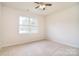 Bedroom with neutral carpet and ample natural light from a large window at 7206 Forrest Rader Dr, Mint Hill, NC 28227