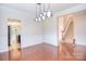 Dining area featuring hardwood floors, hanging light fixture, wainscoting, and a view of the staircase at 7206 Forrest Rader Dr, Mint Hill, NC 28227