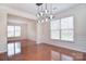 Formal dining room featuring hardwood floors, wainscoting, hanging light fixture, and a large window at 7206 Forrest Rader Dr, Mint Hill, NC 28227