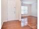 Bright entryway features hardwood floors, white door and trim, and a view into the living room at 7206 Forrest Rader Dr, Mint Hill, NC 28227