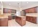 Spacious kitchen with stainless steel appliances, tile floors, granite countertops, and a central island at 7206 Forrest Rader Dr, Mint Hill, NC 28227