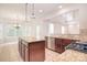 Gourmet kitchen features granite countertops, stainless steel appliances, and a center island with breakfast bar at 7206 Forrest Rader Dr, Mint Hill, NC 28227