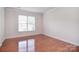 Bright living room showcasing hardwood floors, large window letting in an abundance of natural light at 7206 Forrest Rader Dr, Mint Hill, NC 28227