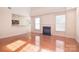 Open concept living room featuring a fireplace, hardwood floors, and views of the kitchen at 7206 Forrest Rader Dr, Mint Hill, NC 28227