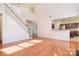 Spacious living room featuring hardwood floors, staircase, and kitchen pass-through at 7206 Forrest Rader Dr, Mint Hill, NC 28227