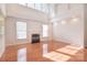 Bright living room with hardwood floors, fireplace, and vaulted ceilings with large windows at 7206 Forrest Rader Dr, Mint Hill, NC 28227