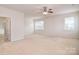 Bright main bedroom with two windows and a ceiling fan, showcasing the spaciousness at 7206 Forrest Rader Dr, Mint Hill, NC 28227