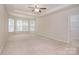 Large main bedroom with tray ceilings, carpet flooring, and ample natural light at 7206 Forrest Rader Dr, Mint Hill, NC 28227