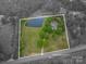 Aerial view of property with bordering pond, mature trees, and ample space at 7701 Gold Hill Rd, Rockwell, NC 28138