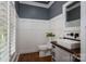 Powder room with shiplap walls, dark wood floors, and modern fixtures at 7701 Gold Hill Rd, Rockwell, NC 28138