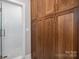 Bathroom featuring glass enclosed tiled shower and wooden linen closet at 7701 Gold Hill Rd, Rockwell, NC 28138