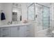 Elegant bathroom with modern vanity, framed mirror, and glass-enclosed tub-shower at 7701 Gold Hill Rd, Rockwell, NC 28138