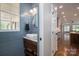 Powder room with a vessel sink and a view into the kitchen at 7701 Gold Hill Rd, Rockwell, NC 28138