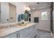 Bright bathroom with double sink vanity and mosaic tile flooring at 7701 Gold Hill Rd, Rockwell, NC 28138