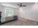 Bright bedroom featuring carpet, large built-in closets, and a ceiling fan at 7701 Gold Hill Rd, Rockwell, NC 28138