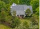 A well-maintained home with a classic backyard design surrounded by lush trees and landscaping providing a serene outdoor space at 7701 Gold Hill Rd, Rockwell, NC 28138