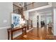 Grand foyer featuring hardwood floors, staircase with iron railings, and an open layout, creating an inviting entrance at 7701 Gold Hill Rd, Rockwell, NC 28138