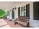 Comfortable front porch with a bench and rocking chairs at 7701 Gold Hill Rd, Rockwell, NC 28138