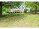 Well-manicured front yard with lush lawn and mature trees at 7701 Gold Hill Rd, Rockwell, NC 28138