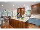 Kitchen view showcasing a center island with cooktop, stainless appliances, and an open floor plan at 7701 Gold Hill Rd, Rockwell, NC 28138
