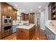 Bright, spacious kitchen features custom cabinets, an island with cooktop, and stainless steel appliances at 7701 Gold Hill Rd, Rockwell, NC 28138