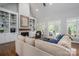 Bright living room featuring a cozy fireplace, built-in shelving, and an open layout, creating an inviting living space at 7701 Gold Hill Rd, Rockwell, NC 28138