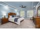 Serene bedroom with plush carpet, natural light, and ceiling fan at 7701 Gold Hill Rd, Rockwell, NC 28138