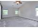 A spacious bedroom with neutral walls, carpeted floors, and large windows for natural light at 8607 Cedardale Ridge Ct, Charlotte, NC 28269