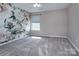 Bedroom featuring plush carpeting, floral wallpaper, and a window offering natural light at 8607 Cedardale Ridge Ct, Charlotte, NC 28269