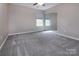 A carpeted bedroom with mirrored closet doors, and a window letting in plenty of natural light at 8607 Cedardale Ridge Ct, Charlotte, NC 28269