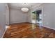 Dining room with hardwood floors, modern light fixture, and sliding door to the backyard at 8607 Cedardale Ridge Ct, Charlotte, NC 28269