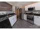 Kitchen with stainless steel appliances, white cabinets, tile backsplash and black granite countertops at 8607 Cedardale Ridge Ct, Charlotte, NC 28269