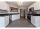 Modern kitchen featuring white cabinets, stainless steel appliances, granite countertops, and tile backsplash at 8607 Cedardale Ridge Ct, Charlotte, NC 28269