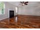 Well-lit living room with hardwood floors, fireplace, and windows providing ample natural light at 8607 Cedardale Ridge Ct, Charlotte, NC 28269