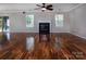 Large living room with hardwood floors, a fireplace, and large windows offering plenty of natural light at 8607 Cedardale Ridge Ct, Charlotte, NC 28269