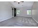 The main bedroom features neutral walls, carpeted floors, and large windows for natural light at 8607 Cedardale Ridge Ct, Charlotte, NC 28269