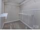 An empty walk-in closet with plenty of wire shelves and a carpeted floor, ready to be used at 8607 Cedardale Ridge Ct, Charlotte, NC 28269