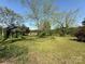 Large backyard featuring mature trees and a well-maintained lawn at 8664 Nc 742 S Hwy, Wadesboro, NC 28170