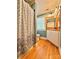 Cozy bathroom with hardwood floors, neutral vanity, and decorative shower curtain at 8664 Nc 742 S Hwy, Wadesboro, NC 28170