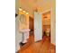 A bathroom showing a pedestal sink, toilet, and hallway at 8664 Nc 742 S Hwy, Wadesboro, NC 28170