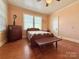 Charming bedroom featuring hardwood floors and a wood bench at 8664 Nc 742 S Hwy, Wadesboro, NC 28170