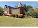 Brick home featuring a side view and lush landscaping at 8664 Nc 742 S Hwy, Wadesboro, NC 28170