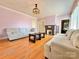 Cozy living room with fireplace, hardwood floors, two couches and built-in bookshelves at 8664 Nc 742 S Hwy, Wadesboro, NC 28170