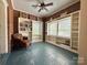 A room with an abundance of natural light, brick walls and shelving, and blue flooring at 8664 Nc 742 S Hwy, Wadesboro, NC 28170