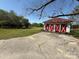 Detached three-bay garage, with a red roof and white accents, in a grassy lot at 8664 Nc 742 S Hwy, Wadesboro, NC 28170