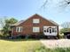 View of the back of a brick home with a patio at 8664 Nc 742 S Hwy, Wadesboro, NC 28170