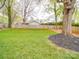 Spacious backyard offering a private retreat with well-maintained lawn and mature trees at 901 Burnley Rd, Charlotte, NC 28210